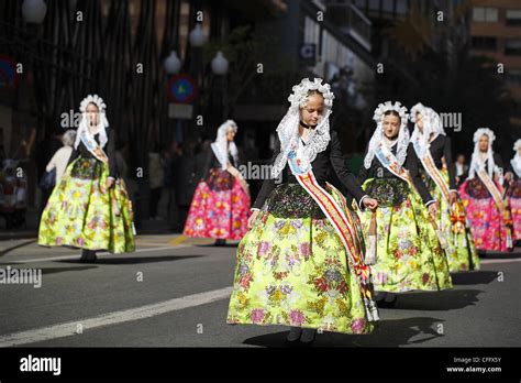 Spanish girls wearing traditional clothing during the street procession ...