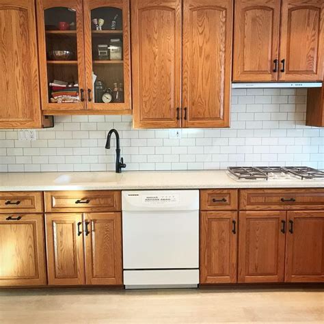 Oak cabinets with cream subway tiles & dark grout | Oak kitchen remodel ...