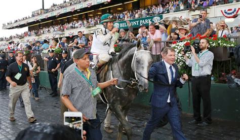 Part owner Bobby Flay (right) leads Creator, with jockey Javier ...