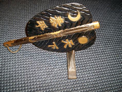 Japanese war fan (gunsen) made of iron, bamboo and lacquer depicting the sun (1800-50) on ...