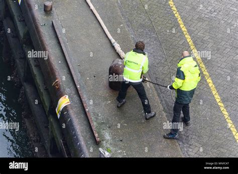 Two men mooring a ferry in the port of IJmuiden, Netherlands Stock ...