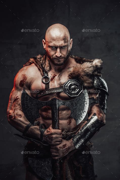 Armed with two handed axe dangerous bald viking warrior Stock Photo by fxquadro