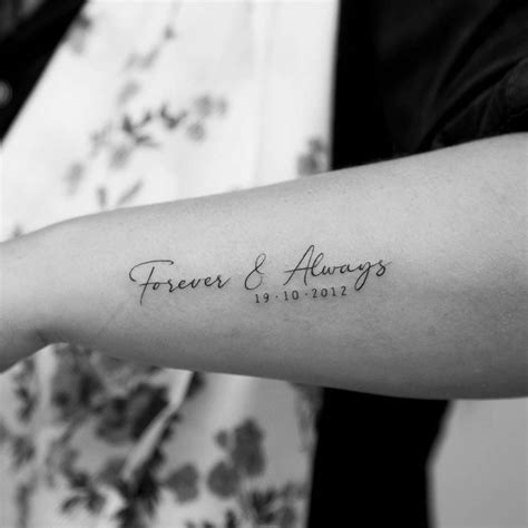 "Forever & Always" lettering tattoo on the forearm.