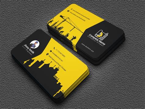 two business cards with yellow and black designs on the front, one is for construction companies