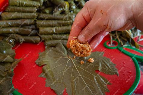 Premium Photo | Stuffed grape leaves. preparation of dolma from grape leaves. traditional ...