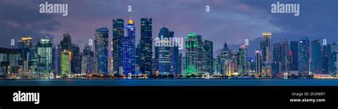 The skyline of Doha, Qatar after sunset Stock Photo - Alamy