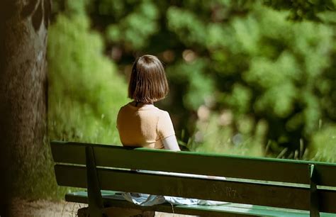 Girl sitting alone on bench