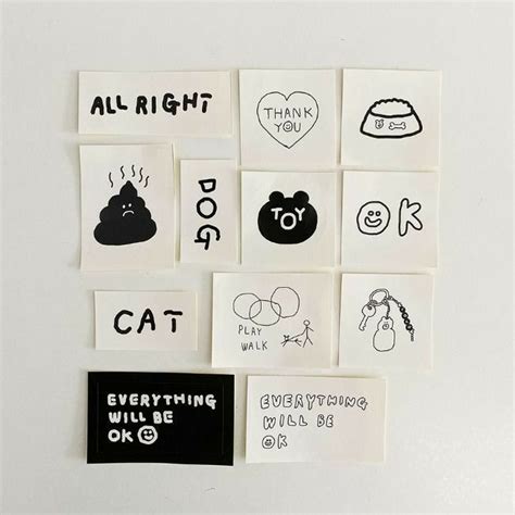 several different stickers on a white surface with words and symbols written in black ink