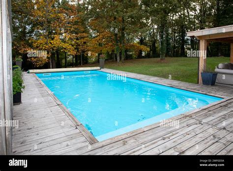 wooden corner of swimming pool with blue water Stock Photo - Alamy