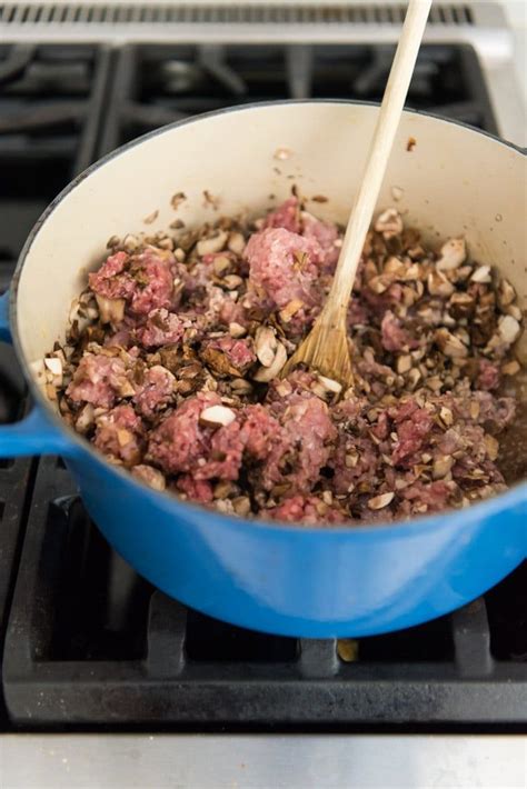 An image of a dutch oven on a stove filled with ground beef, ground ...