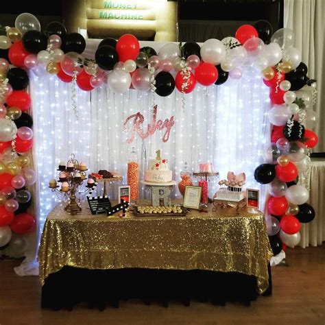 a table topped with lots of balloons and cake