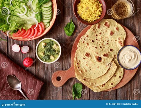 Indian Vegetarian Flat Bread Chapati with Vegetables and Hummus on a Wooden Table Stock Image ...