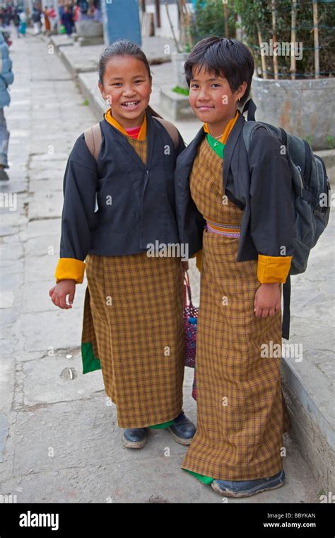 Students wearing traditional dress uniform in street in Thimphu Bhutan ...