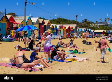 People having fun on the Brighton Beach with colorful Bathing Boxes as ...