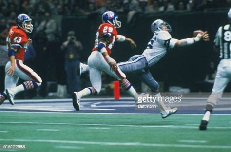 Receiver Butch Johnson of the Dallas Cowboys reaches out to catch a ...