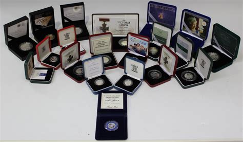 A collection of Royal Mint silver commemorative coins, including a Queen Mother Centenary silver pie