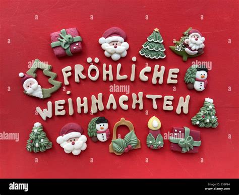 Fröhliche Weihnachten, Merry Christmas in german language with wooden letters and marzipan ...