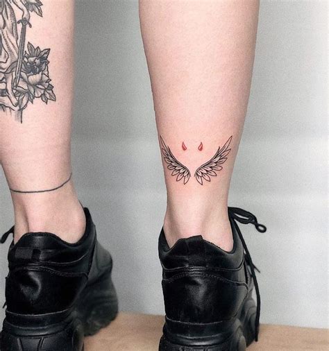 a woman's legs with tattoos and black shoes