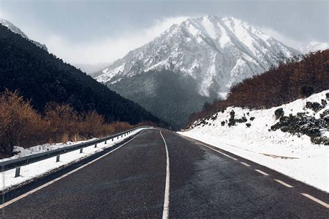 "Winter Road With A Snowy Mountains In The Background" by Stocksy ...