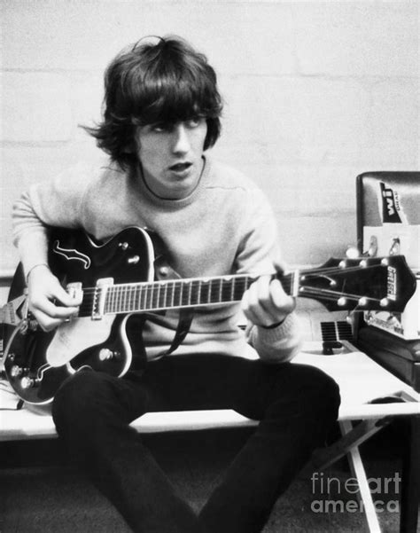 George Harrison Playing Guitar #1 by Bettmann