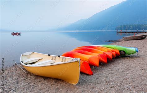 Overview of Lake McDonald after sunset with kayaks in foreground. Lake McDonald is the largest ...