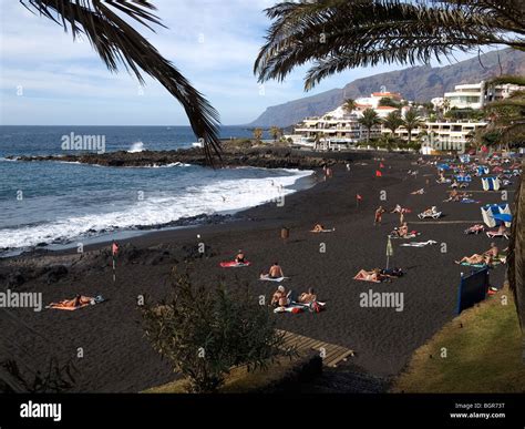 A public beach of black volcanic sand Playa de la Arena Puerto Santiago ...