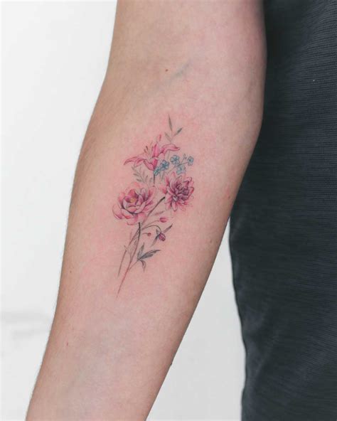 Tattoo of a lily, forget-me-nots, dahlia, peony, and fuchsia ...