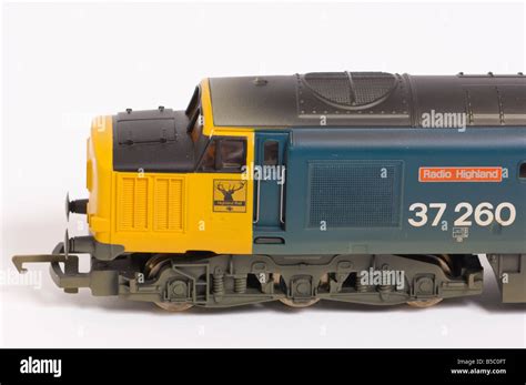 Close up of a Hornby electric class 37 diesel model train in blue and yellow livery shot against ...