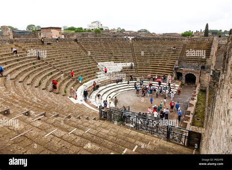 Tourists at an ancient roman amphitheatre, Pompeii Archaeological site ...