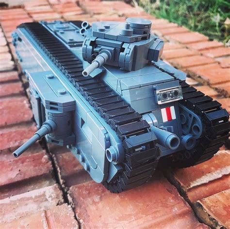 a toy tank sitting on top of a brick floor