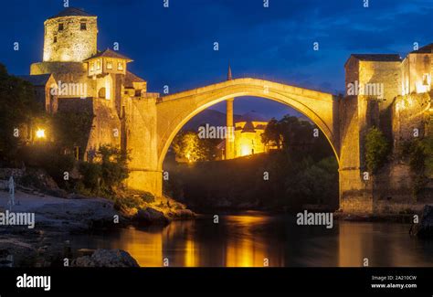 Old bridge and panorama of Mostar by night Stock Photo - Alamy