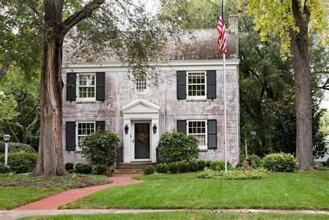 The exterior of historic brick houses in DC is enhanced by landscaping ...