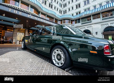 A green painted Rolls-Royce Phantom parked outside the luxury Peninsula ...