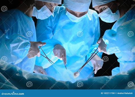 Group of Surgeons at Work in Operating Theater Toned in Blue Stock ...