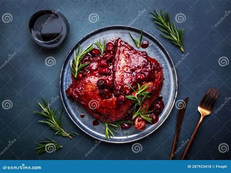 Baked Duck Legs in Wine and Cherry Sauce with Rosemary. Gourmet Dinner with Red Wine Glass Stock ...