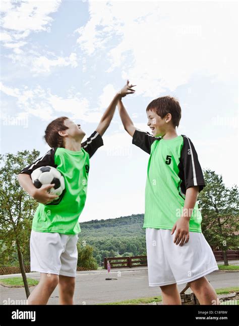 Twin brothers high five Stock Photo - Alamy