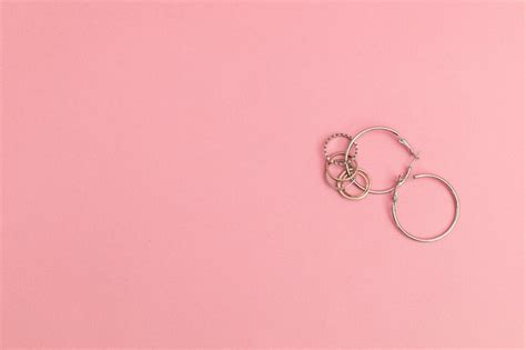 Premium Photo | Silver jewelry on a pink background