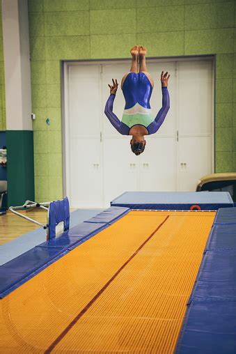 Young Gymnastics Athlete Doing Backflip Stock Photo - Download Image Now - iStock