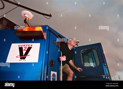 Storm chasing. Tornado researcher monitoring a severe thunderstorm from ...