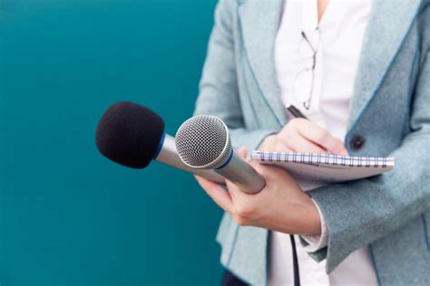 News reporter or TV journalist at press conference, holding microphone ...