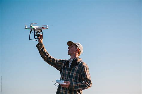 "Man Flying A Drone On The Coast" by Stocksy Contributor "Kkgas" - Stocksy