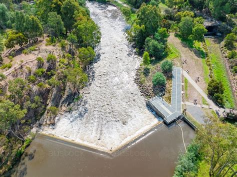 Image of Aerial view of water rushing over a waterfall and down a river ...