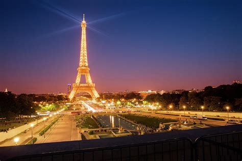 Eiffel Tower lit up at night Paris France Photograph by Sun Gallery ...