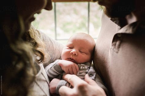 "Mom And Dad Holding Newborn Baby Boy" by Stocksy Contributor "Lea ...