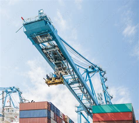 Shipping containers and a container crane Stock Photo | Adobe Stock