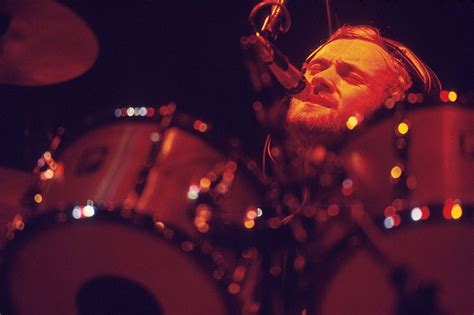 Phil Collins performs on stage with Genesis, playing drums and singing, circa 1975. (Photo by ...