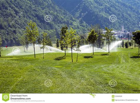 Sprinklers on golf course stock image. Image of recreation - 25302029