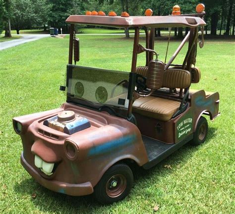 an old fashioned golf cart is parked in the grass