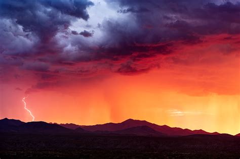 Sunset Storm Clouds With Lightning Strike Stock Photo - Download Image Now - iStock