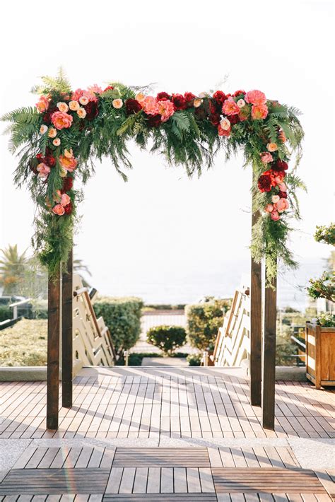 an archway decorated with flowers and greenery